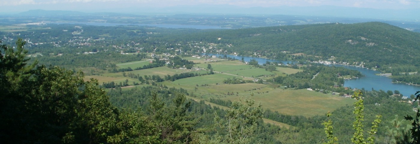 Northern view from Cook Mountain over looking a lake and a small town.